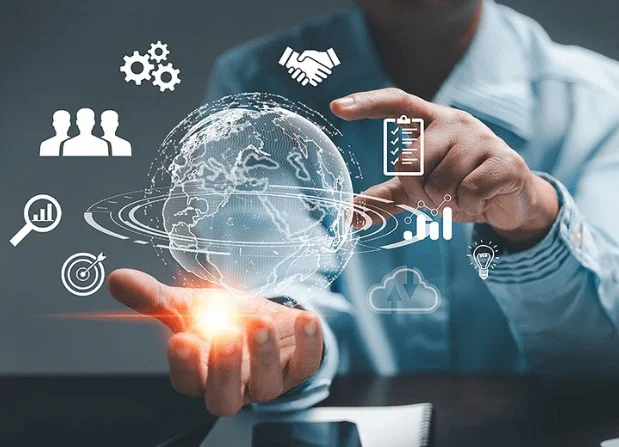 Close-up of a hand interacting with a glowing digital interface showing business icons for teamwork, analytics, and strategy.