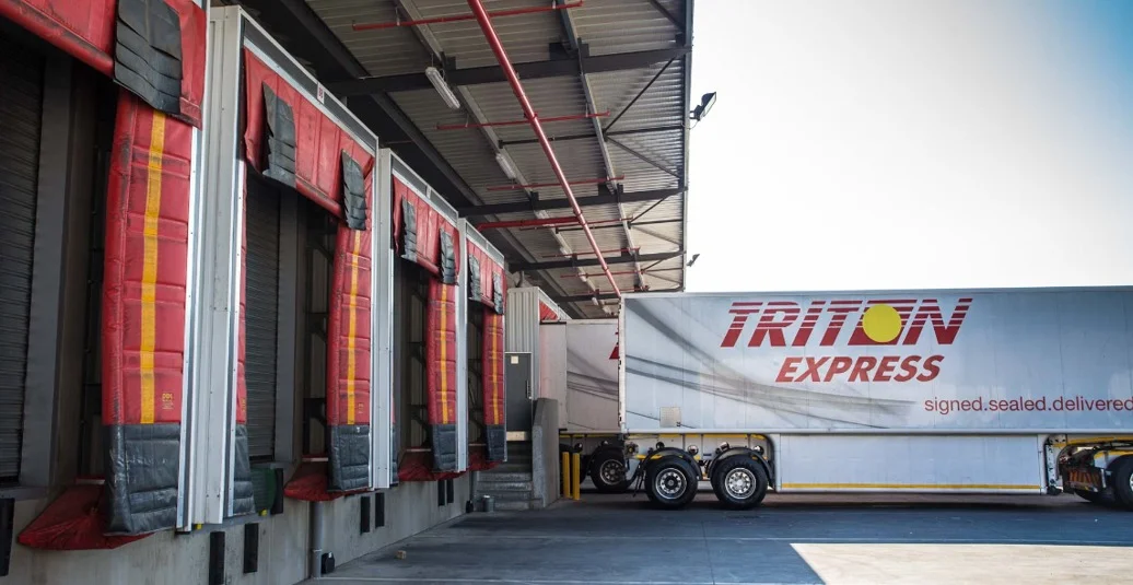 The corporate logo or a professional image of a Triton Express freight vehicle or warehouse facility, representing a leading provider of express road freight and logistics services across Southern Africa. The image highlights the company's "signed. sealed. delivered." ethos and its extensive distribution network.