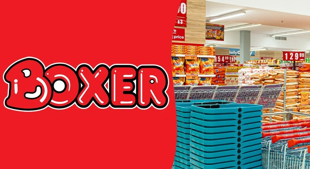A composite graphic featuring the red and white Boxer Superstores logo on the left. The right side shows a bright retail interior with stacks of teal shopping baskets, red trolleys, and shelves stocked with bulk grocery items like maize meal and snacks.